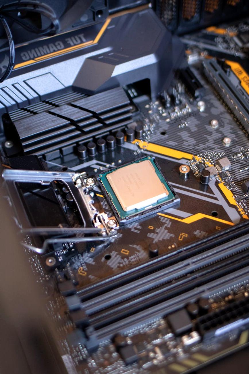 Stack of technical books and a laptop on CPU architecture